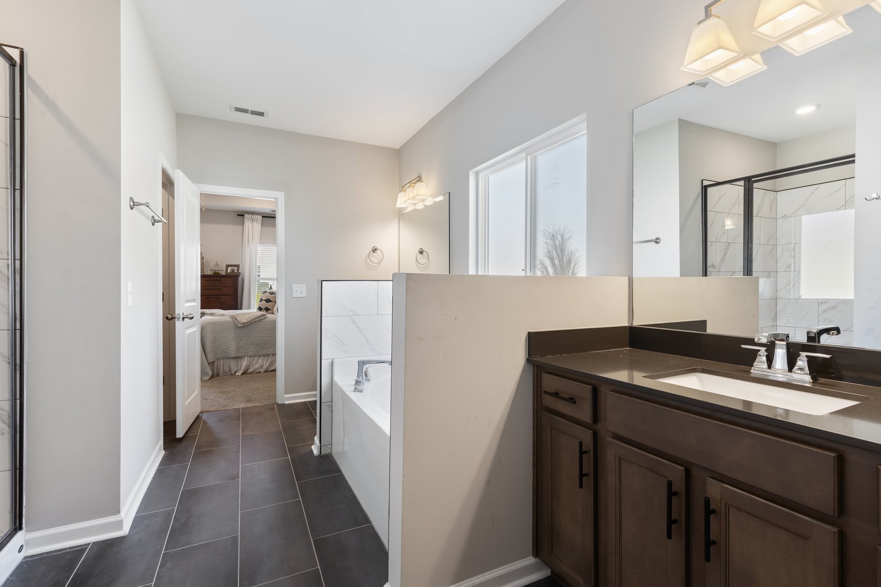 658 Castle Road Mount Juliet, TN 37122 - Photo 13 of 24 a en suite bathroom with a sink a mirror and a shower
