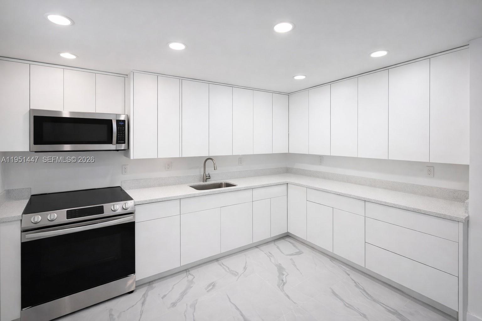 236 Northeast 55th Terrace, Unit 236 Miami, FL 33137 - Photo 1 of 10 a kitchen with a sink and stainless steel appliances
