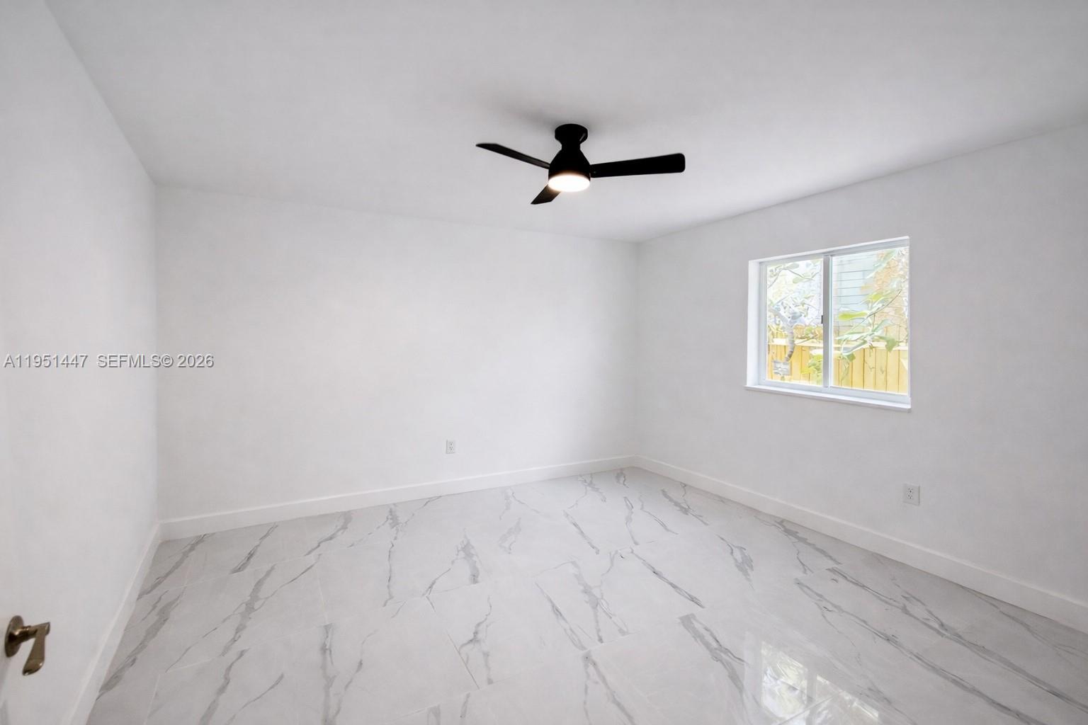 236 Northeast 55th Terrace, Unit 236 Miami, FL 33137 - Photo 5 of 10 an empty room with a window