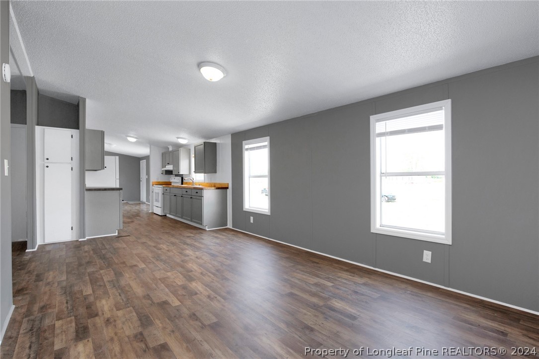 152 Three Bridges Road Rowland, NC 28383 - Photo 7 of 27 a living room with stainless steel appliances kitchen island hardwood floor and a window