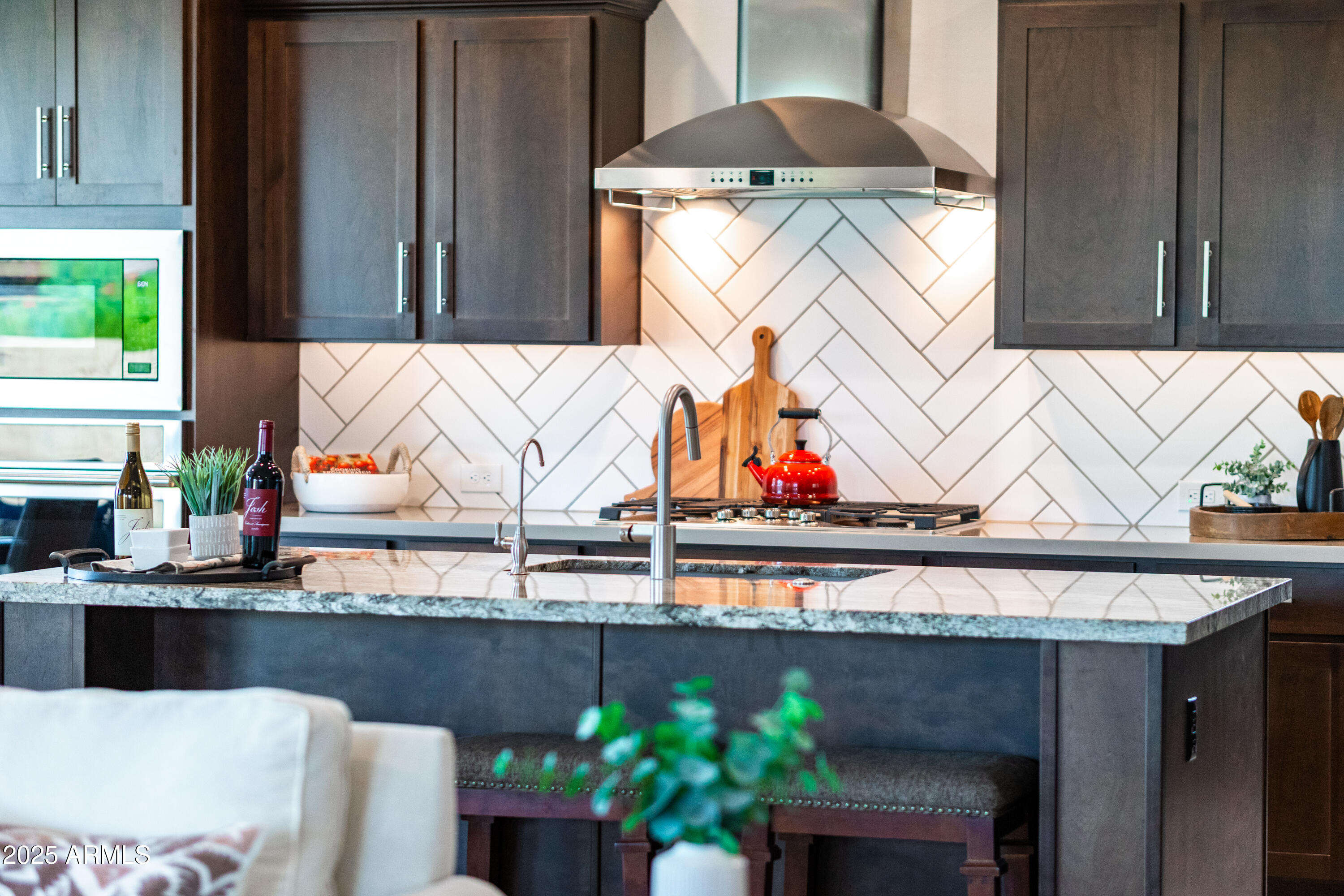 17621 Blaze Lane Rio Verde, AZ 85263 - Photo 11 of 57 a kitchen with an oven a sink and a table with chairs