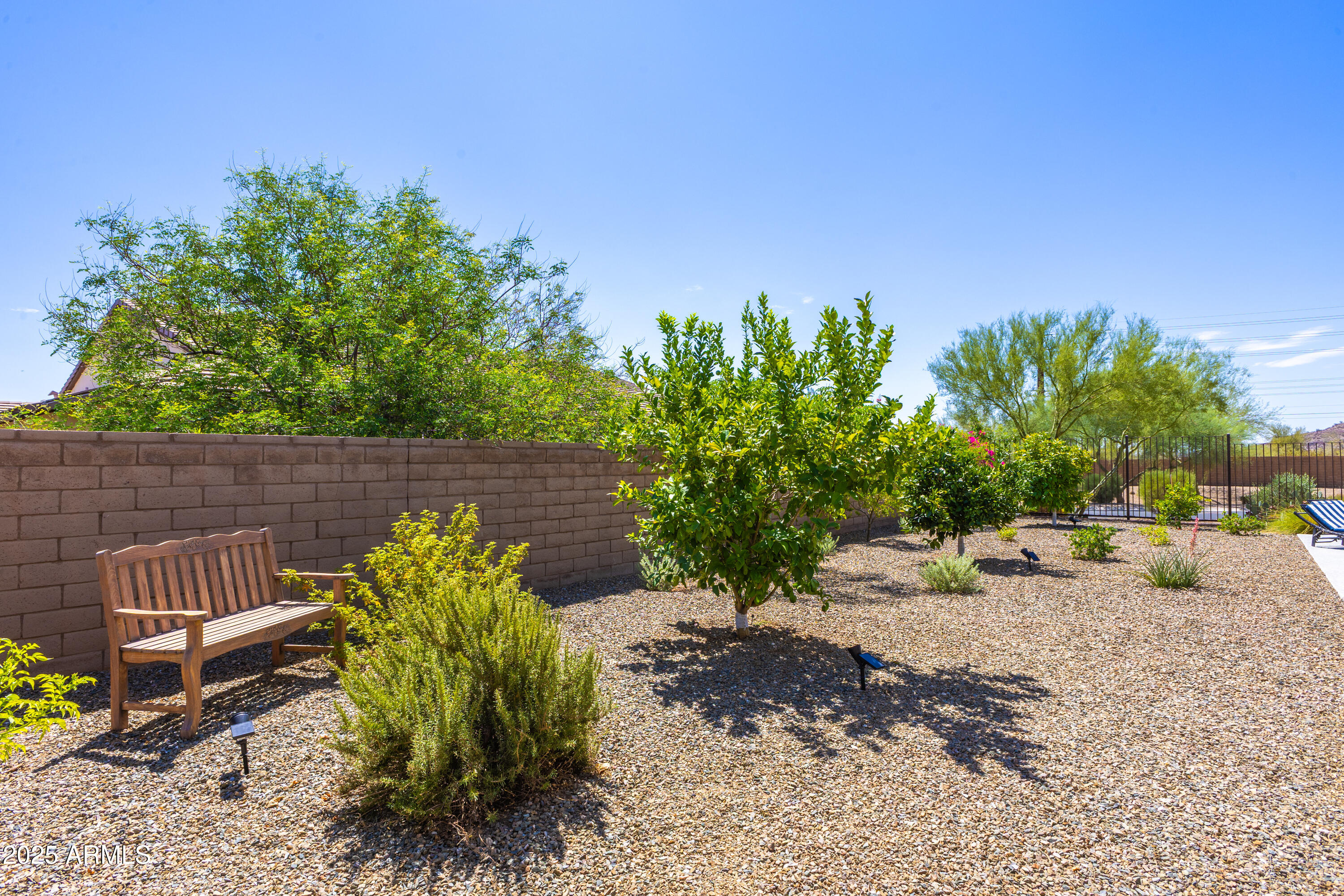 17621 Blaze Lane Rio Verde, AZ 85263 - Photo 40 of 57 a garden with a bench in front of the house