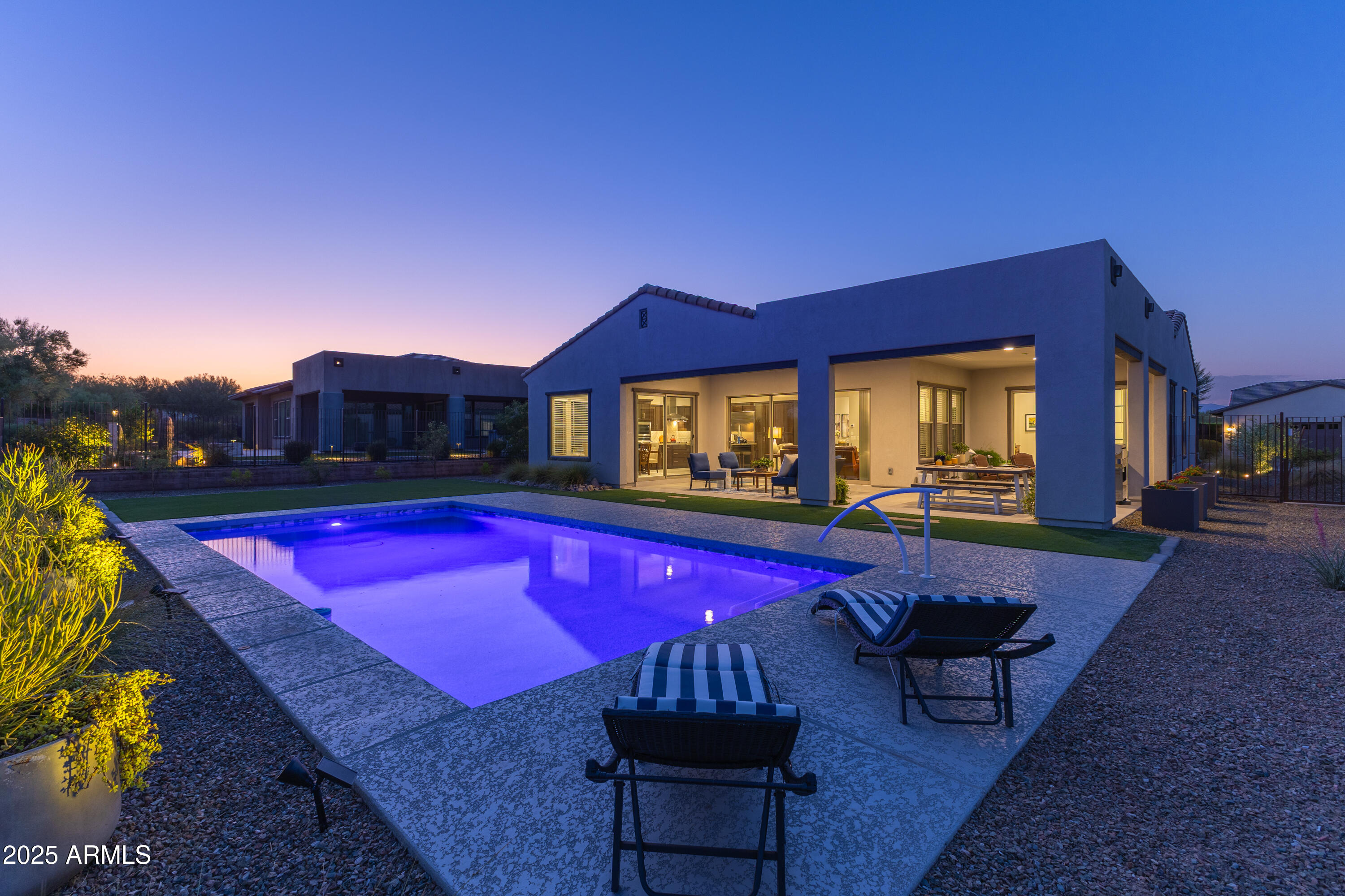 17621 Blaze Lane Rio Verde, AZ 85263 - Photo 42 of 57 a view of a pool with red chairs in front of house