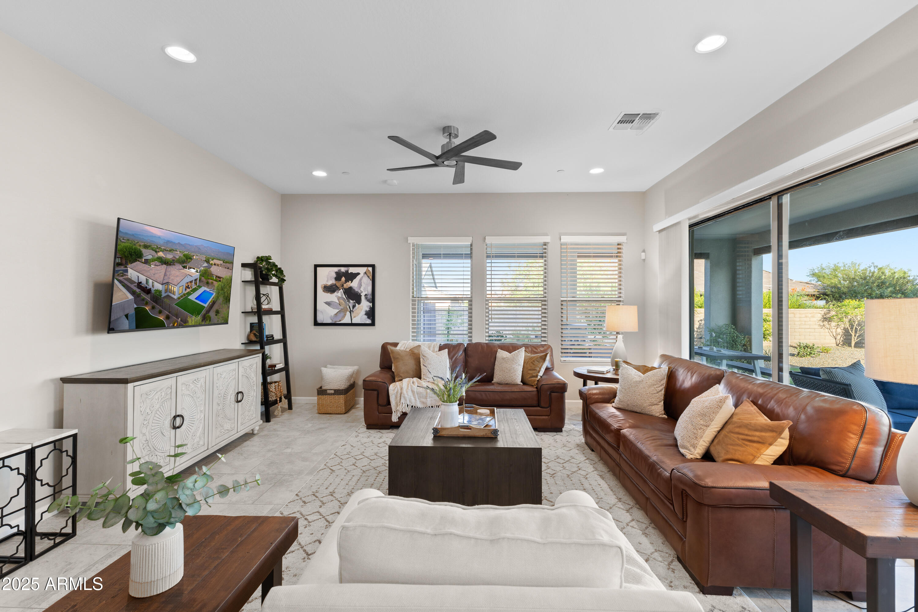 17621 Blaze Lane Rio Verde, AZ 85263 - Photo 6 of 57 a living room with furniture flat screen tv and a large window