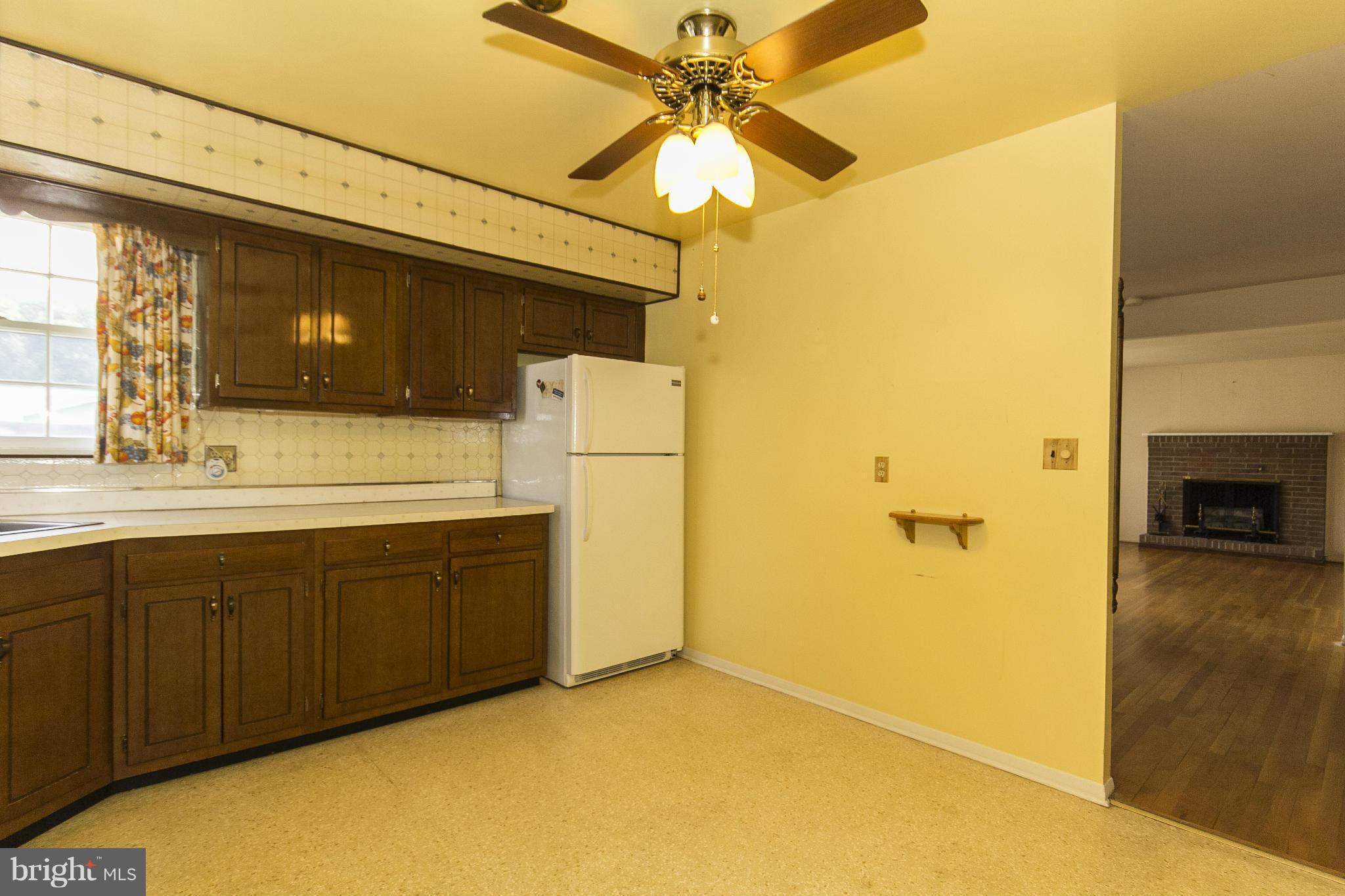 6313 Magdolena Road Baltimore, MD 21237 - Photo 14 of 30 a bathroom with a sink and a refrigerator
