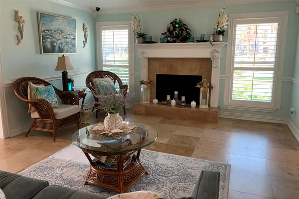 a living room with furniture a window and a fireplace