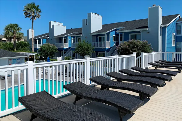 a view of a house with wooden deck outdoor seating