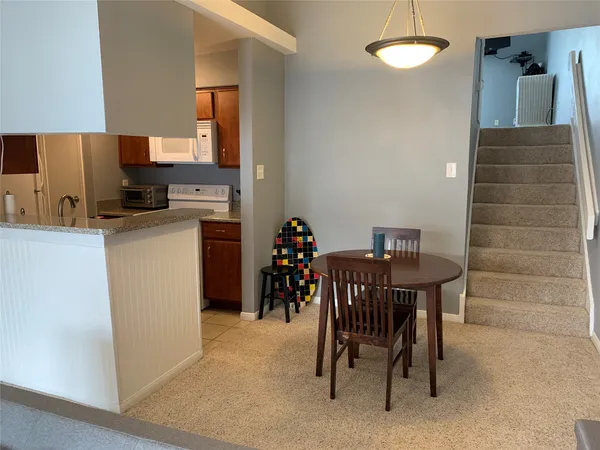 a view of a dining room with furniture and a chandelier