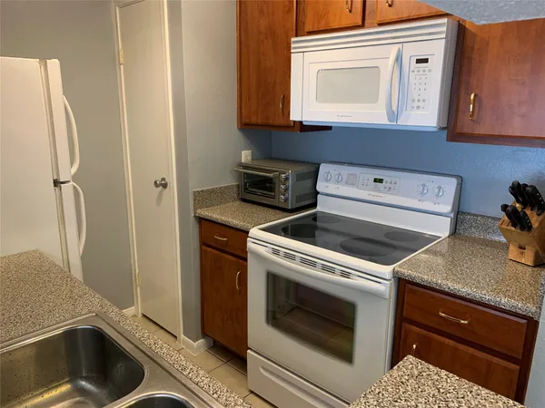 a kitchen with a stove and a refrigerator