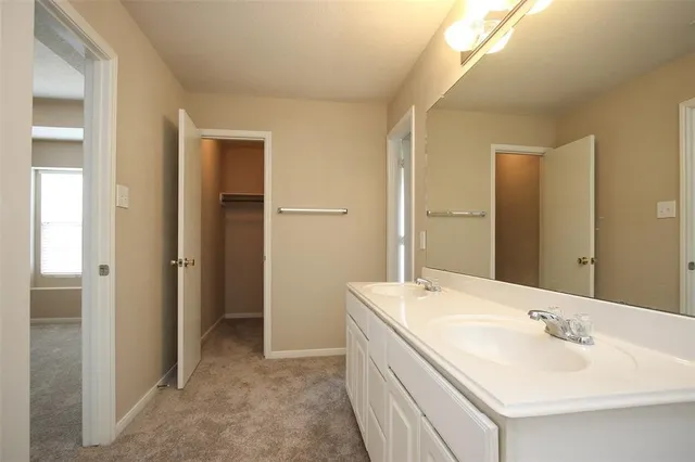a bathroom with a double vanity sink and mirror