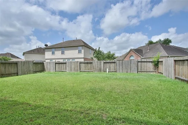a view of a big house with a big yard and large trees