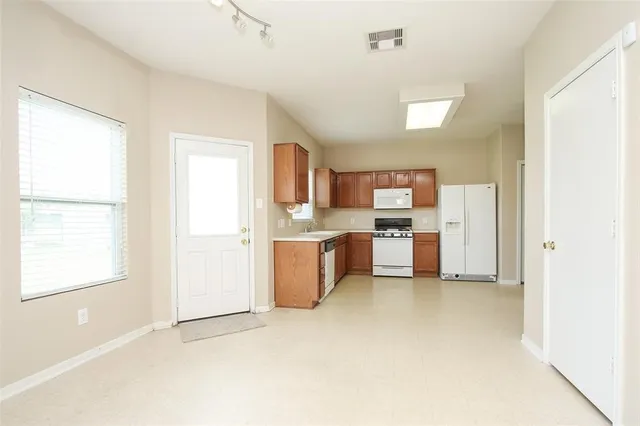 a kitchen with stainless steel appliances granite countertop a refrigerator sink and cabinets