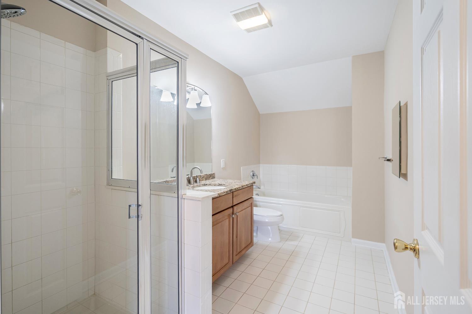 368 Rector Street, Unit 521 Perth Amboy, NJ 08861 - Photo 19 of 41 a bathroom with a granite countertop sink a mirror and a bathtub
