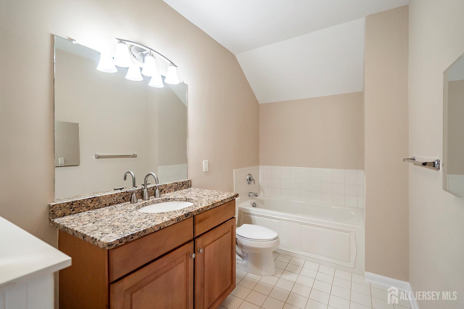 368 Rector Street, Unit 521 Perth Amboy, NJ 08861 - Photo 21 of 41 a bathroom with a granite countertop sink a toilet and bathtub