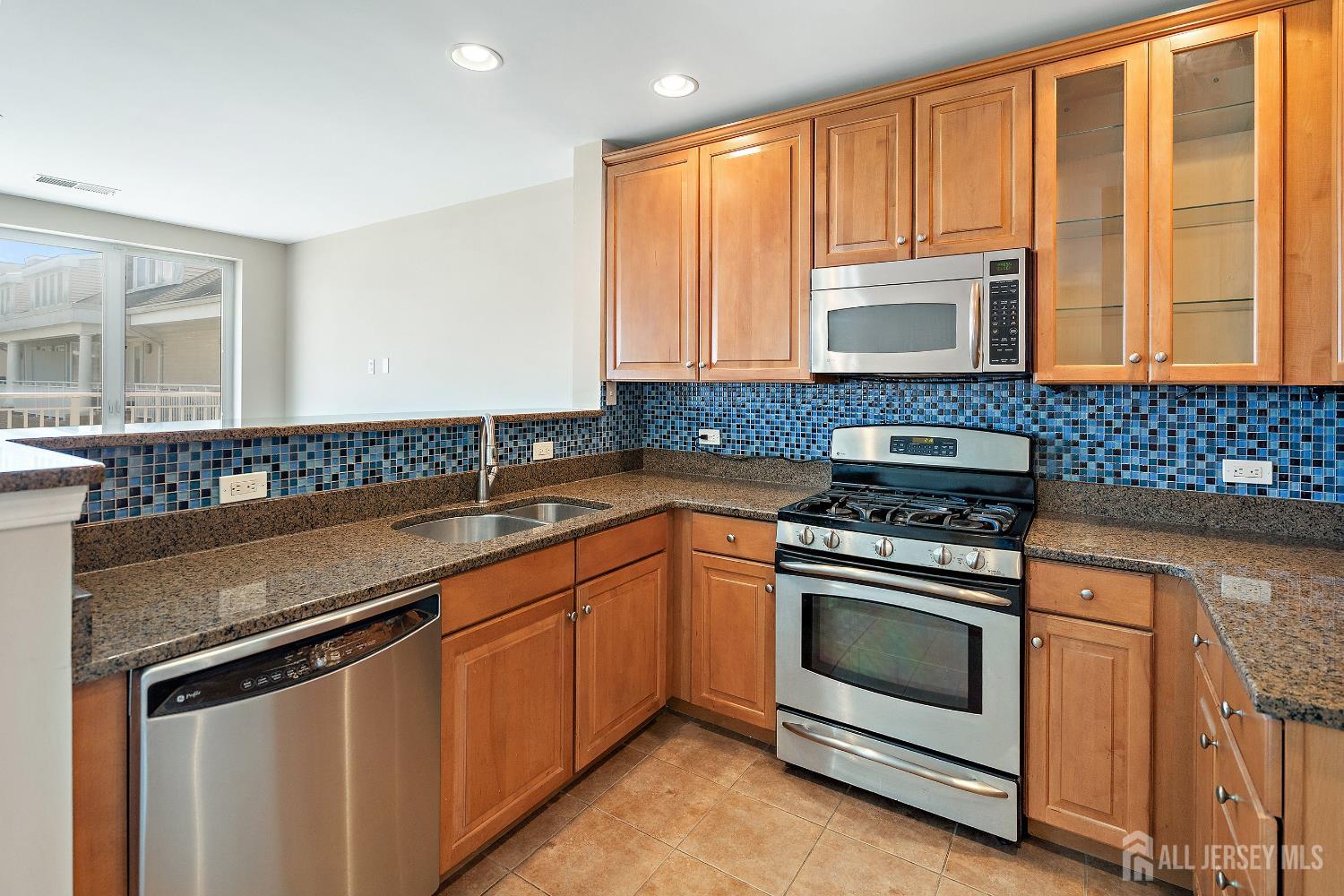 368 Rector Street, Unit 521 Perth Amboy, NJ 08861 - Photo 3 of 41 a kitchen with granite countertop a sink stove and cabinets