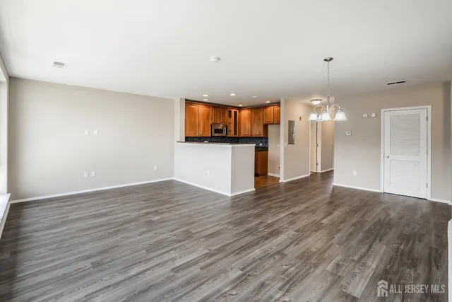 a view of a kitchen with a dishwasher and wooden floor
