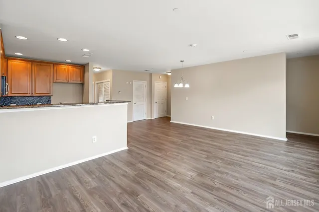 a view of a kitchen with kitchen island wooden floor and center island