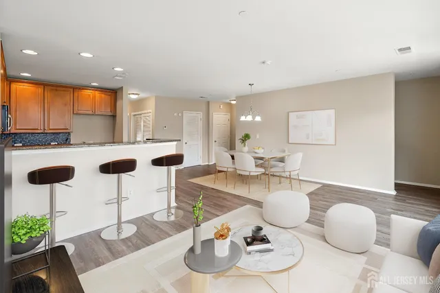 a kitchen with stainless steel appliances granite countertop a dining table and chairs