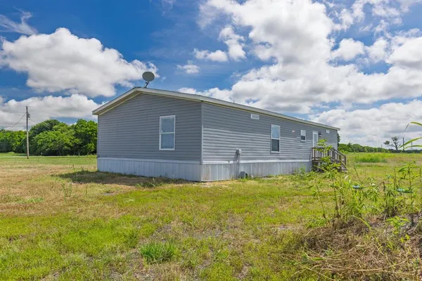 a view of a backyard of the house