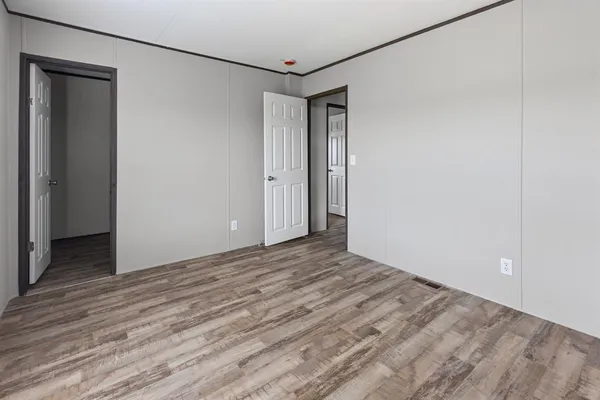 a view of a room with wooden floor