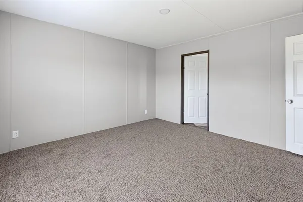 a view of an empty room and closet area