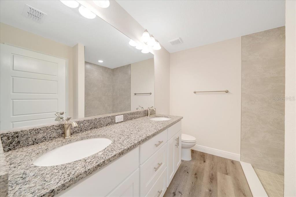 6762 Cherry Road Ocala, FL 34472 - Photo 16 of 29 a bathroom with a granite countertop sink and a mirror