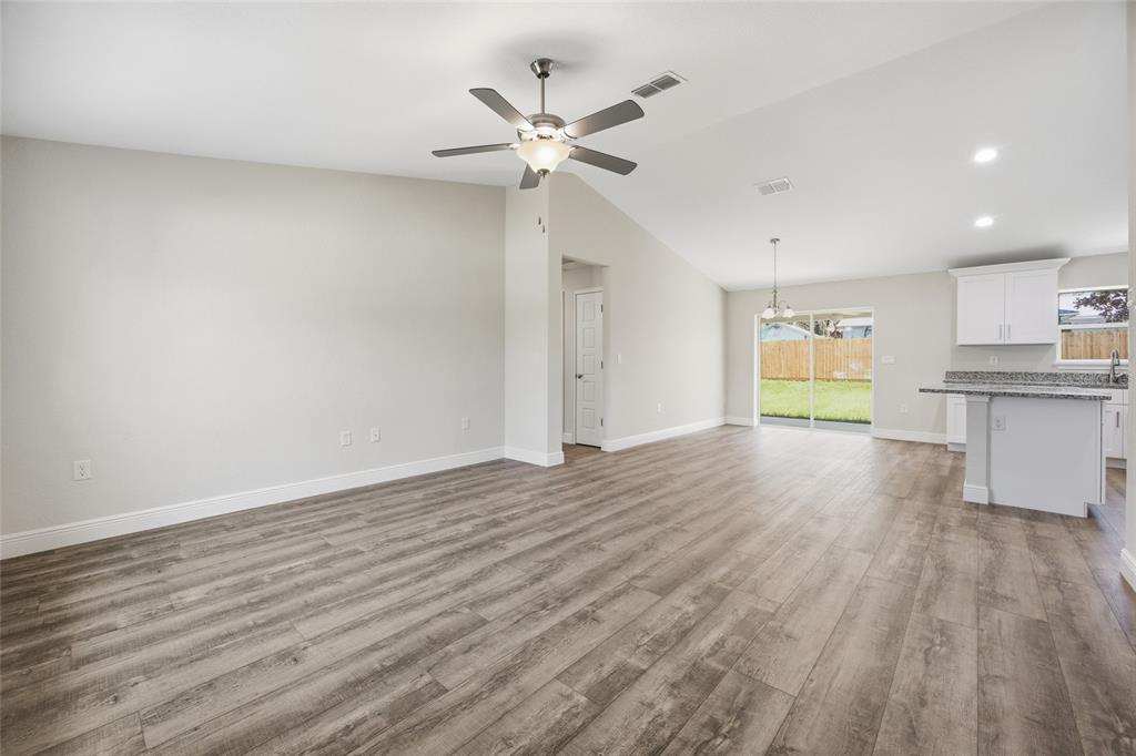 6762 Cherry Road Ocala, FL 34472 - Photo 2 of 29 a view of an empty room with a window and wooden floor