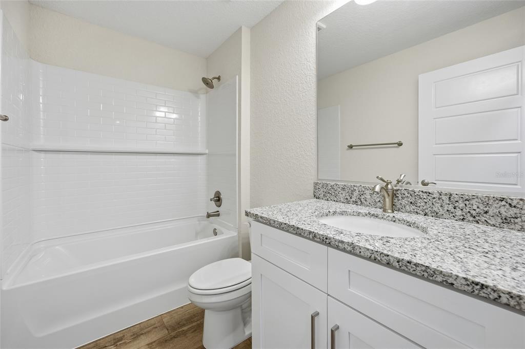 6762 Cherry Road Ocala, FL 34472 - Photo 21 of 29 a bathroom with a granite countertop sink toilet and shower