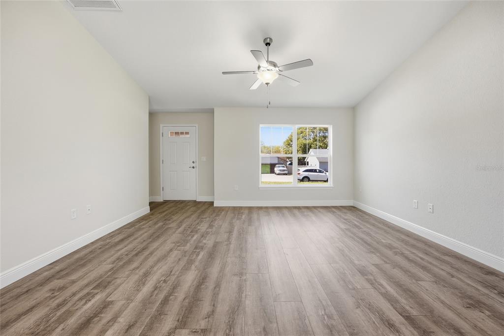 6762 Cherry Road Ocala, FL 34472 - Photo 4 of 29 wooden floor in an empty room with a window
