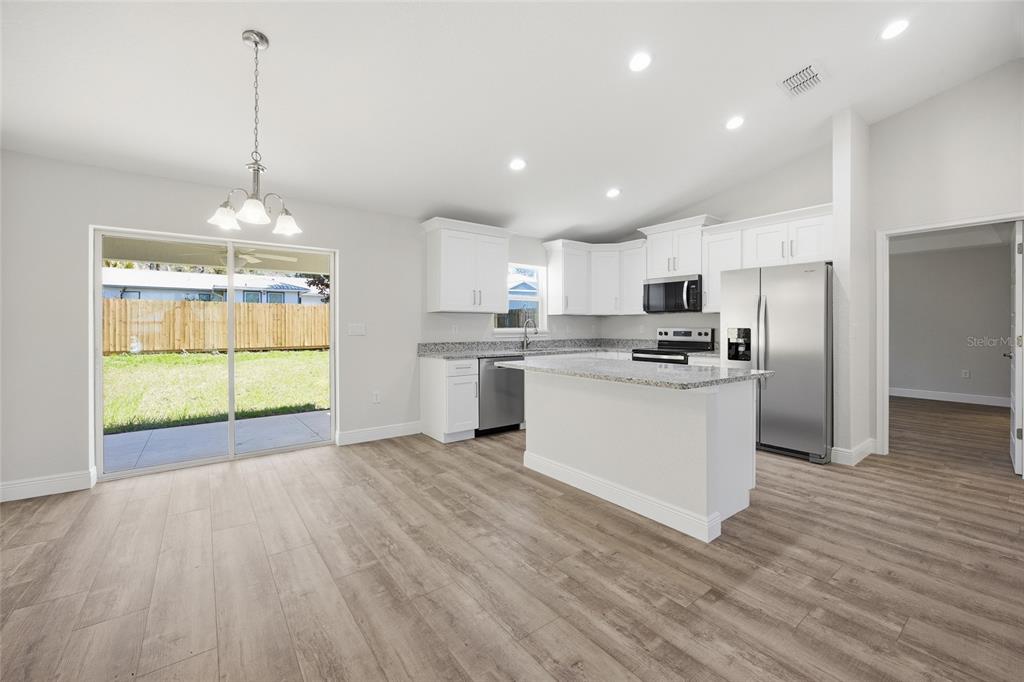 6762 Cherry Road Ocala, FL 34472 - Photo 5 of 29 a view of a kitchen with microwave and refrigerator