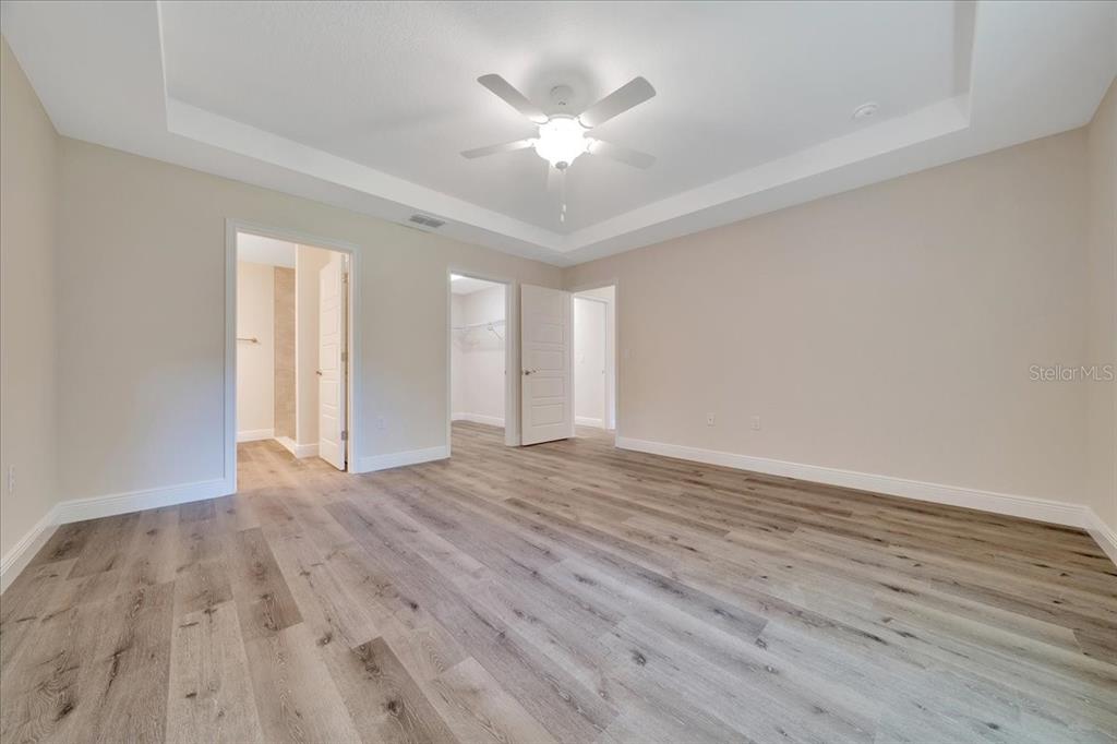 6762 Cherry Road Ocala, FL 34472 - Photo 10 of 29 an empty room with wooden floor and ceiling fan