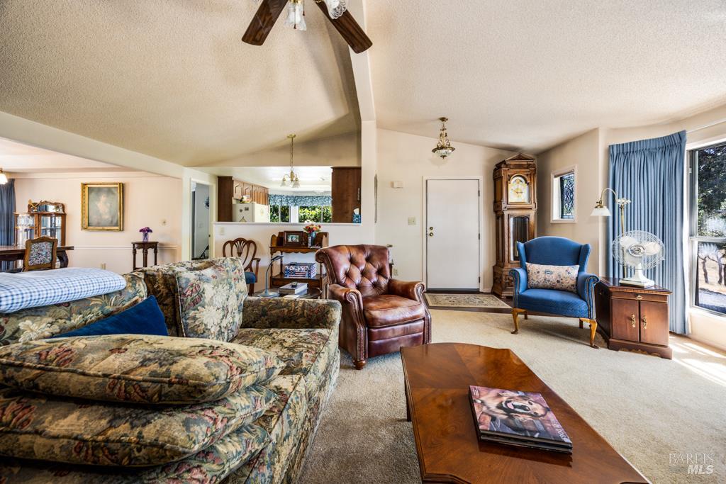 6707 Badger Creek Road Santa Rosa, CA 95409 - Photo 11 of 53 a living room with furniture and a chandelier