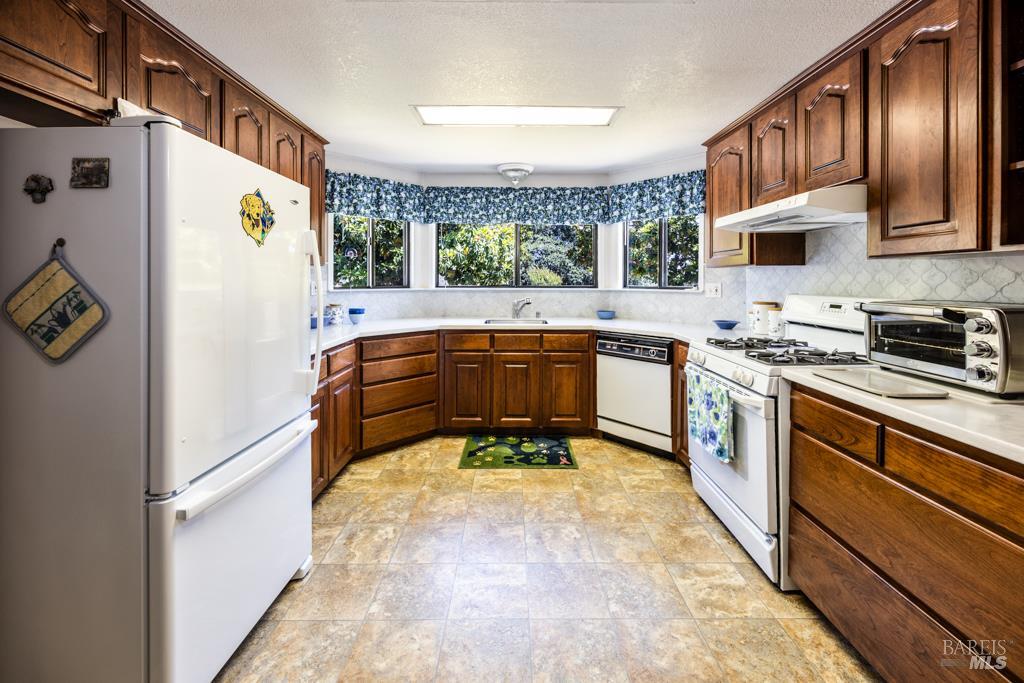 6707 Badger Creek Road Santa Rosa, CA 95409 - Photo 14 of 53 a kitchen with stainless steel appliances granite countertop a sink stove and refrigerator