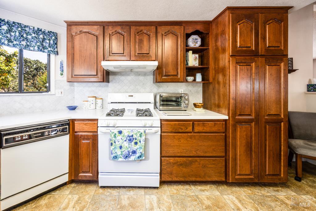 6707 Badger Creek Road Santa Rosa, CA 95409 - Photo 15 of 53 a kitchen with stainless steel appliances granite countertop a refrigerator and a stove