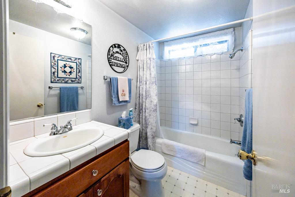 6707 Badger Creek Road Santa Rosa, CA 95409 - Photo 19 of 53 a bathroom with a sink toilet and shower
