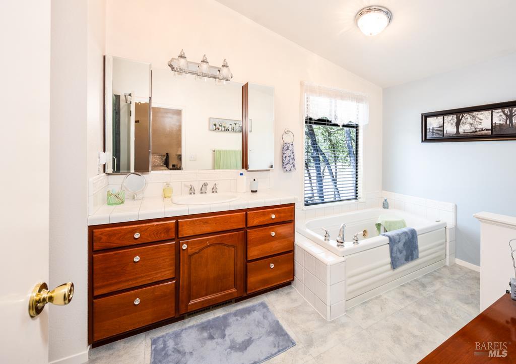 6707 Badger Creek Road Santa Rosa, CA 95409 - Photo 23 of 53 a spacious bathroom with a tub sink and mirror