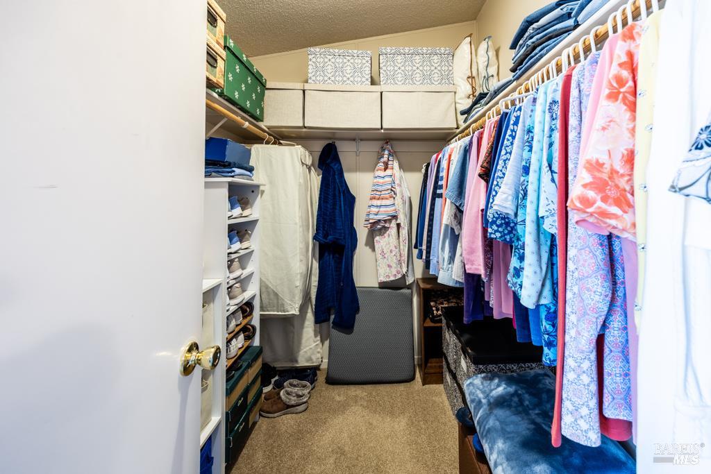 6707 Badger Creek Road Santa Rosa, CA 95409 - Photo 25 of 53 a view of walk in closet with clothes and shoes