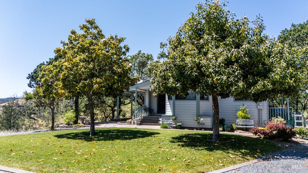 6707 Badger Creek Road Santa Rosa, CA 95409 - Photo 3 of 53 a front view of a house with a yard garage and outdoor seating