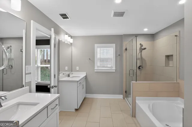 a bathroom with a tub sink and mirror