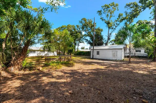 an empty room with fan and entryway