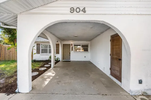 a view of empty room with wooden floor and window