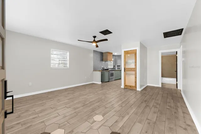 a view of livingroom with hardwood floor and a ceiling fan