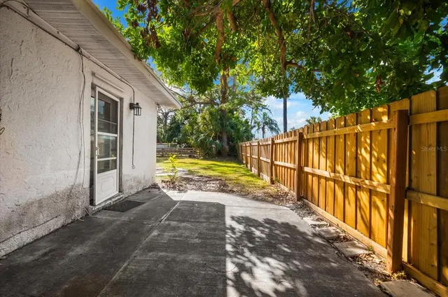 an aerial view of a house with a garden and lake view