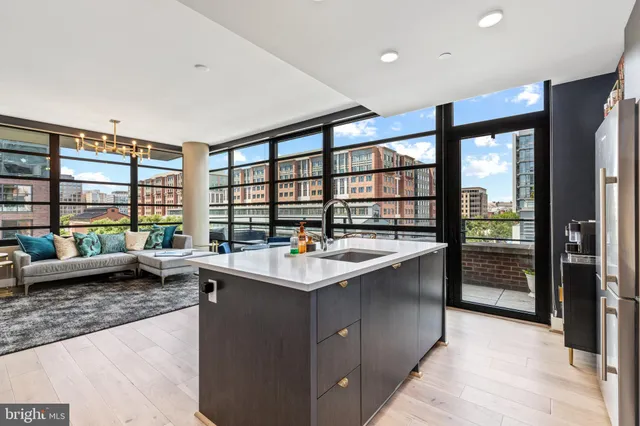 a kitchen with sink and large window