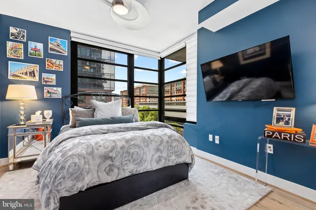 a bedroom with a bed and a flat screen tv