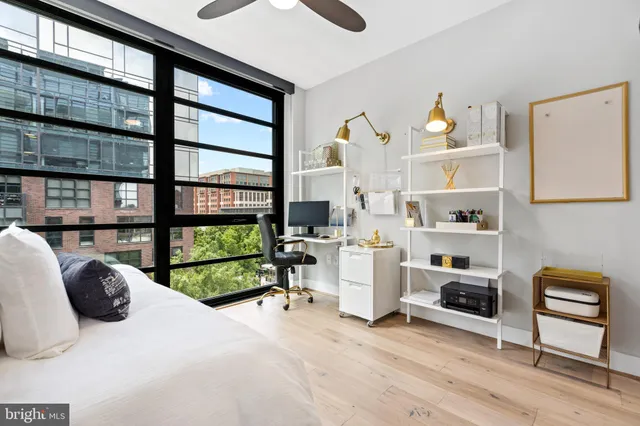 a bedroom with furniture and a large window