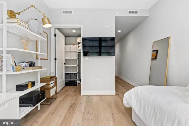 a bedroom with a bed and a walk in closet