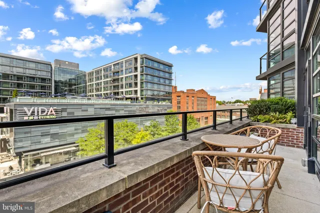 a view of a balcony with table and chairs