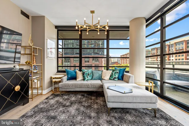 a living room with furniture a rug and a chandelier
