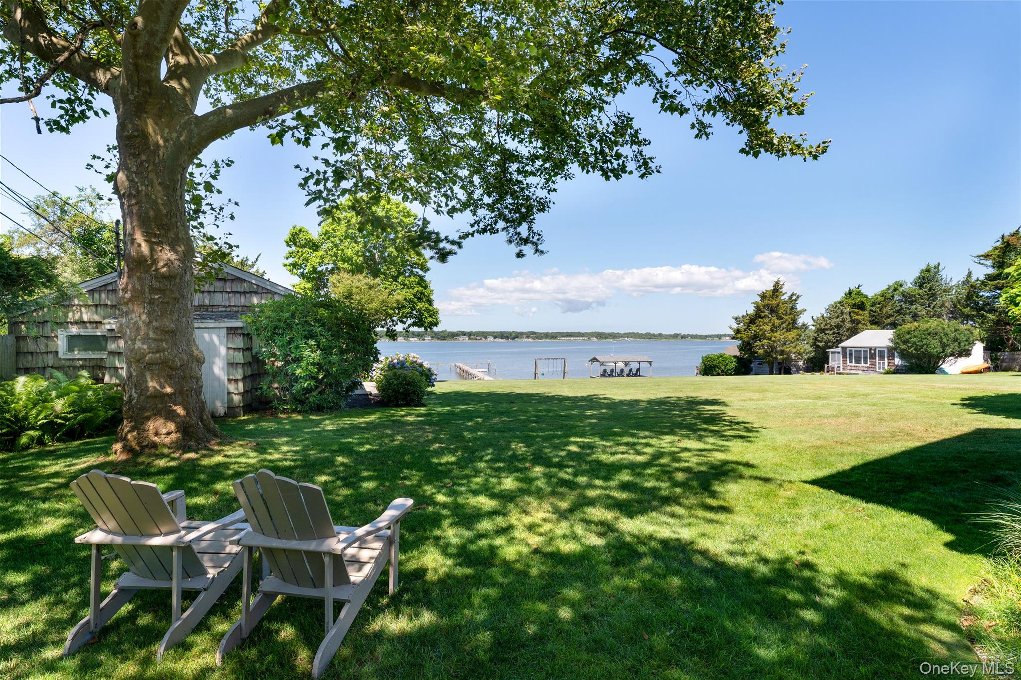 46 Rampasture Road, Unit 3 Hampton Bays, NY 11946 - Photo 20 of 29 View of green lawn with a water view